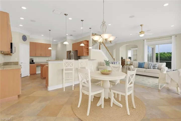 staged virtually Dining space with stairs, arched walkways, a chandelier, recessed lighting, and ceiling fan