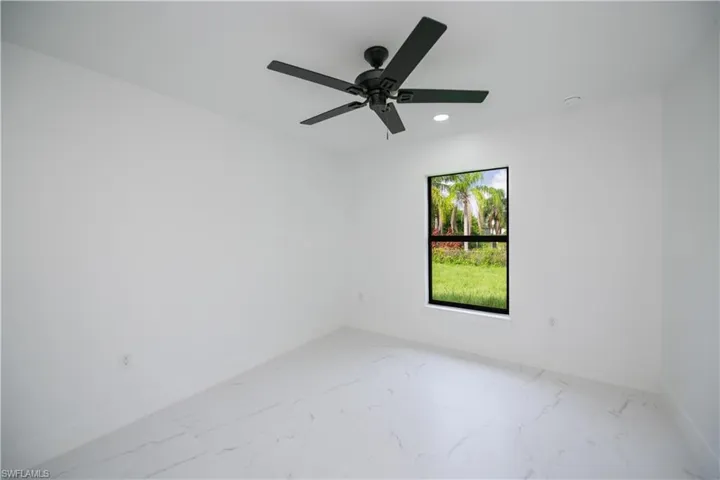 Unfurnished room featuring light marble finish floors, recessed lighting, and ceiling fan