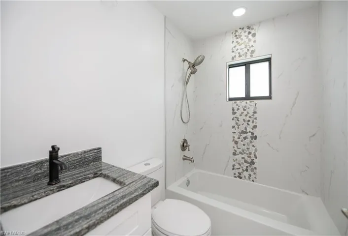 Bathroom with vanity and  shower combination