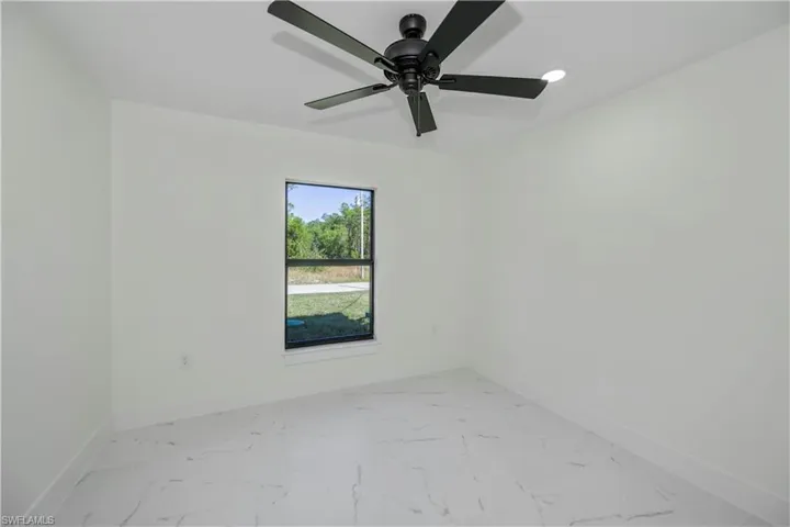 Spare room featuring light marble finish flooring, recessed lighting, and ceiling fan