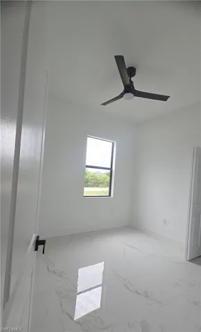 Neutral white walls complemented by large format tile flooring with a subtle veining pattern