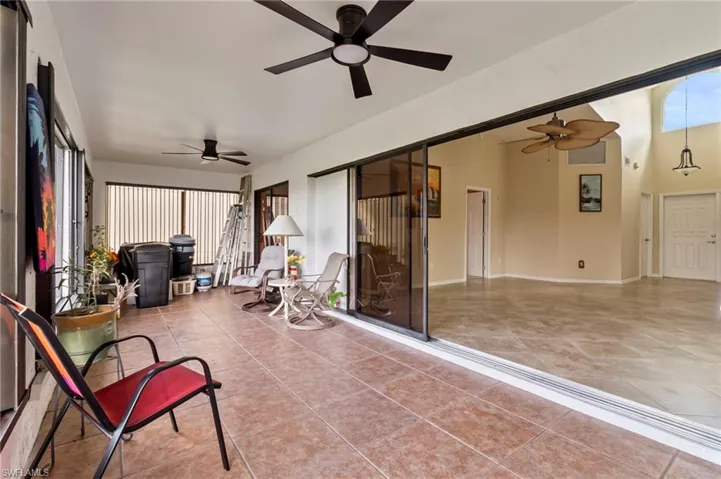 Sunroom / solarium featuring ceiling fan