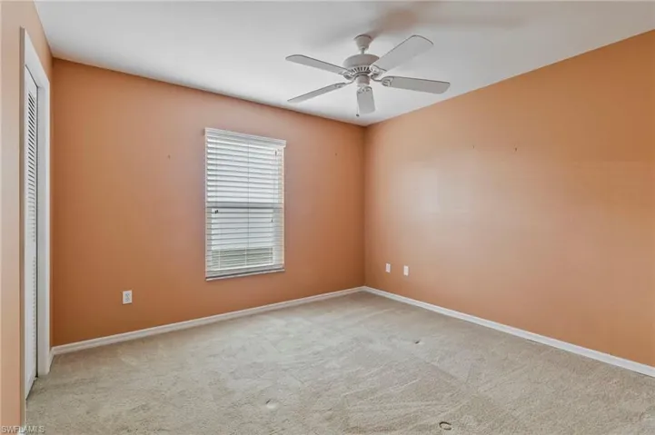 Guest bedroom featuring ceiling fan and light colored carpet