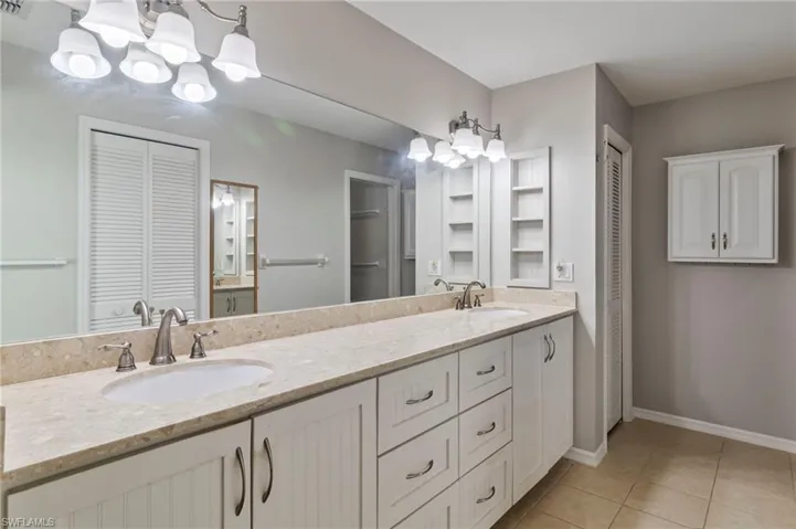 En Suite bathroom featuring tile patterned floors and double vanity