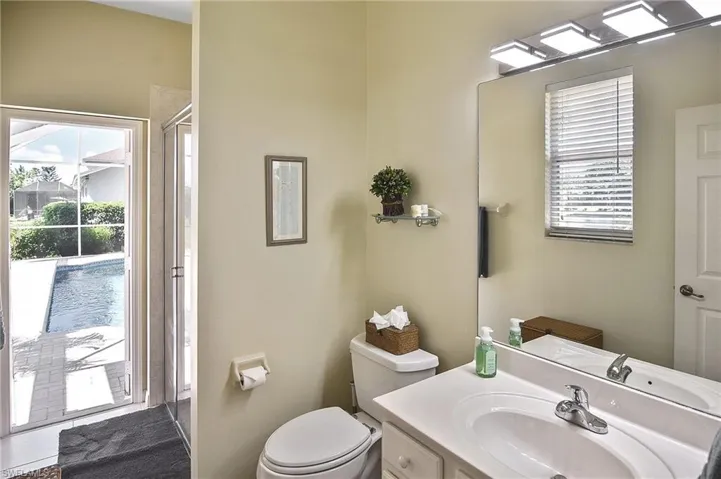 Full bathroom with vanity and a shower with door