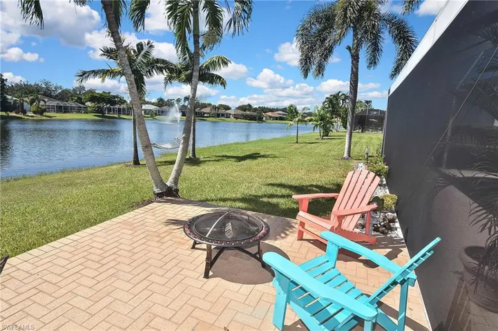 View of patio / terrace with a water view, a fire pit, and a residential view