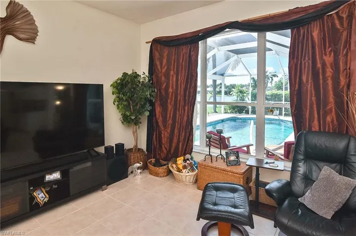Sitting room featuring light tile patterned floors and a sunroom