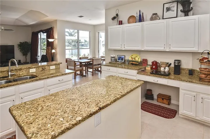 Kitchen featuring white cabinetry and light tile patterned floors
