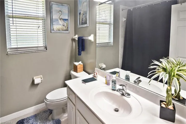 Bathroom with vanity, curtained shower, and tile patterned floors