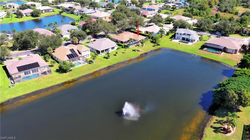 Aerial view of residential area featuring a large body of water