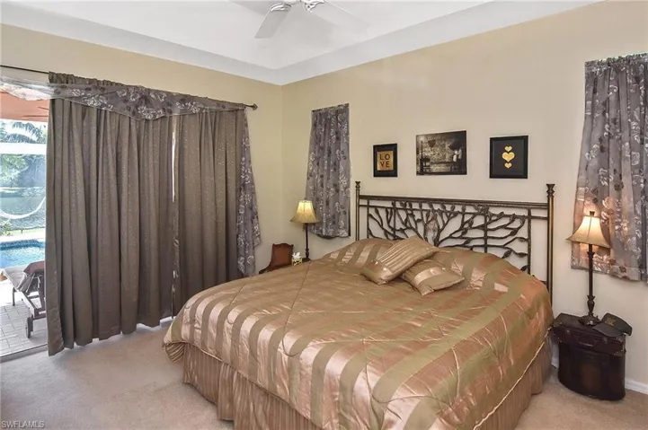 Bedroom featuring carpet, access to exterior, and ceiling fan