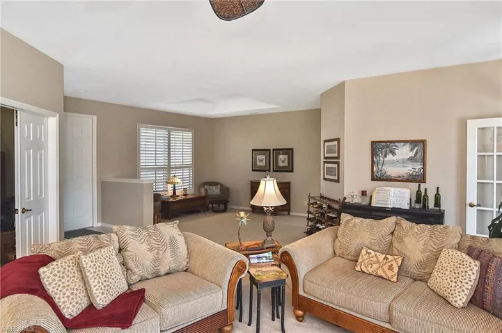 Carpeted living area with baseboards