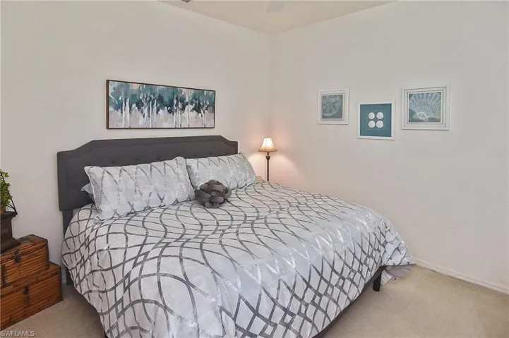 Carpeted bedroom featuring baseboards and ceiling fan