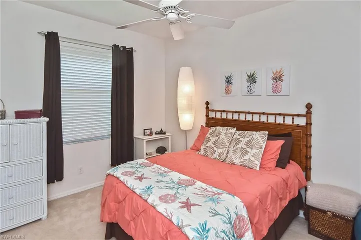Bedroom featuring light colored carpet and a ceiling fan