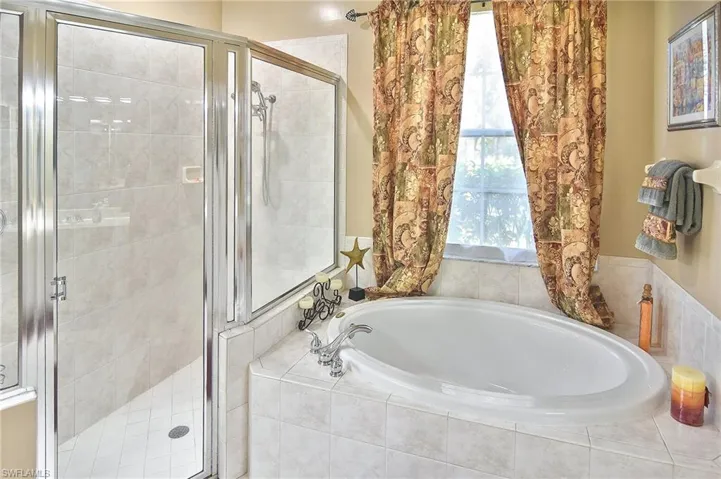 Bathroom with a stall shower and a bath