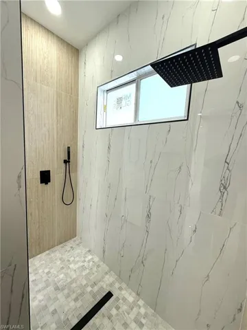 Bathroom with a marble finish shower