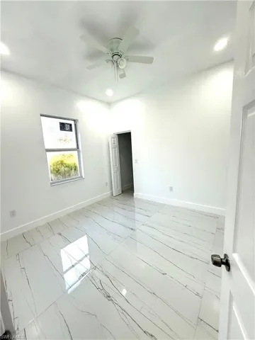 Spare room with recessed lighting, light marble finish floors, and ceiling fan