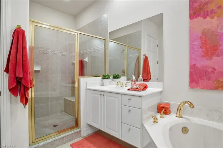 Master bathroom with dual sinks, soaking tub and separate commode.