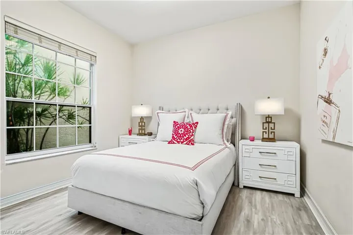 Light guest room with luxury vinyl floors.