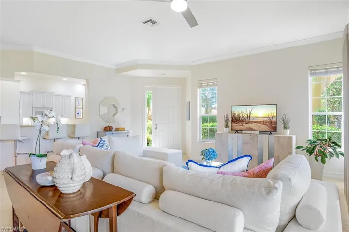 Living room features oversized windows and side front entrance with transom window.