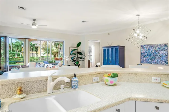Kitchen sink view of sunny courtyard with pool