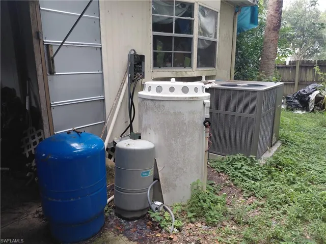 Exterior view of a water pressure tank and a central AC unit