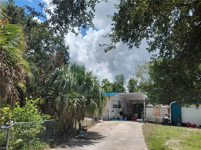 View of front of house featuring concrete driveway