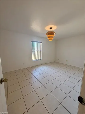 Unfurnished room featuring light tile patterned flooring