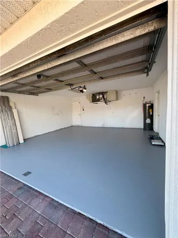 Garage featuring electric water heater