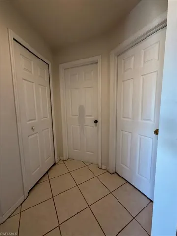 Hallway featuring light tile patterned flooring