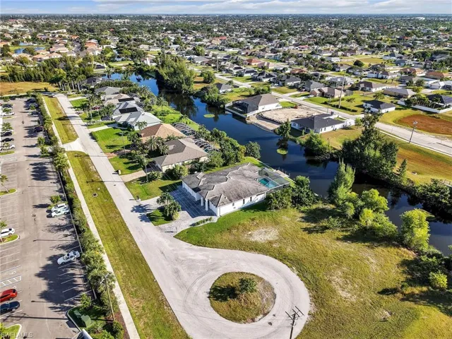 Aerial perspective of suburban area featuring a large body of water
