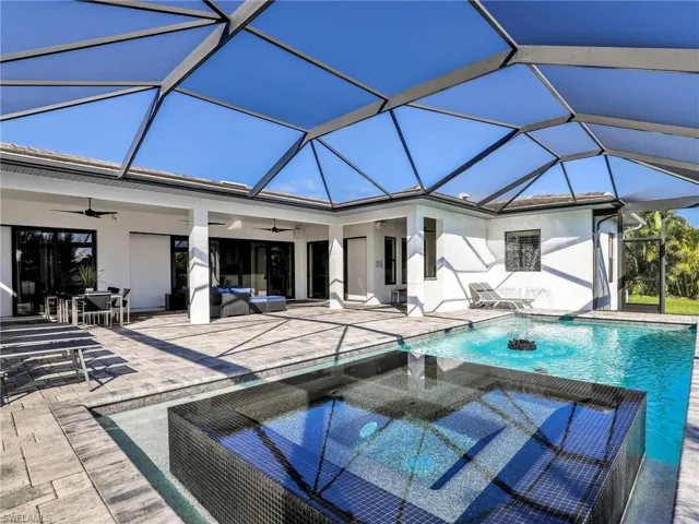 Outdoor pool with outdoor dining space, a sunroom, a ceiling fan, and a patio