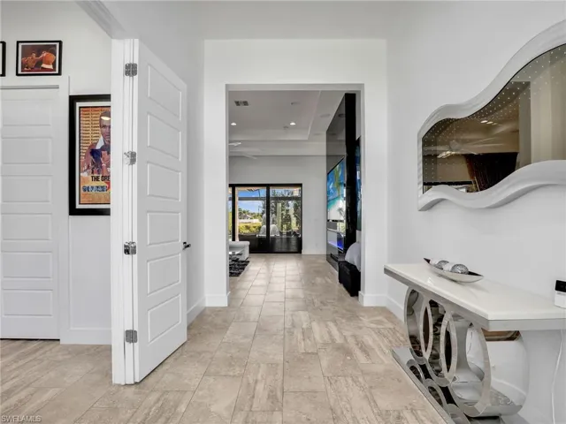 Corridor with baseboards and recessed lighting