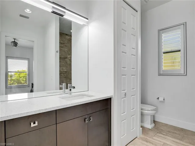 Full bath featuring vanity and wood tiled floors