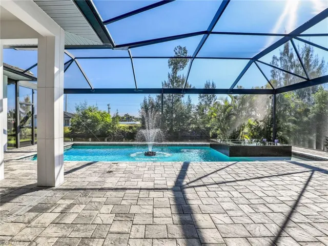 Swimming pool with a sunroom, a lanai, and a patio