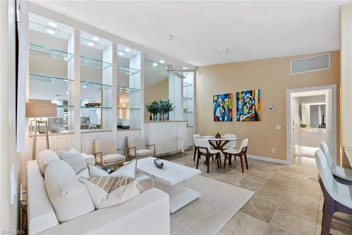 Living room featuring a ceiling fan and built in shelves
