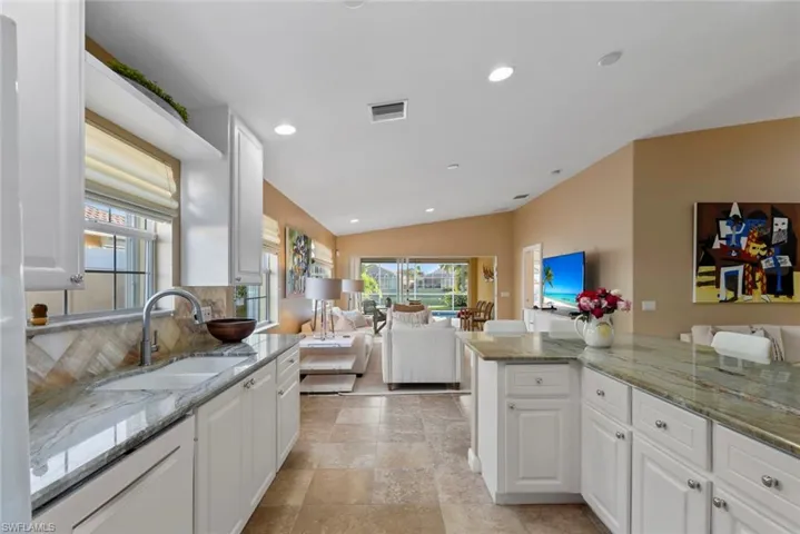 Kitchen with lofted ceiling, recessed lighting