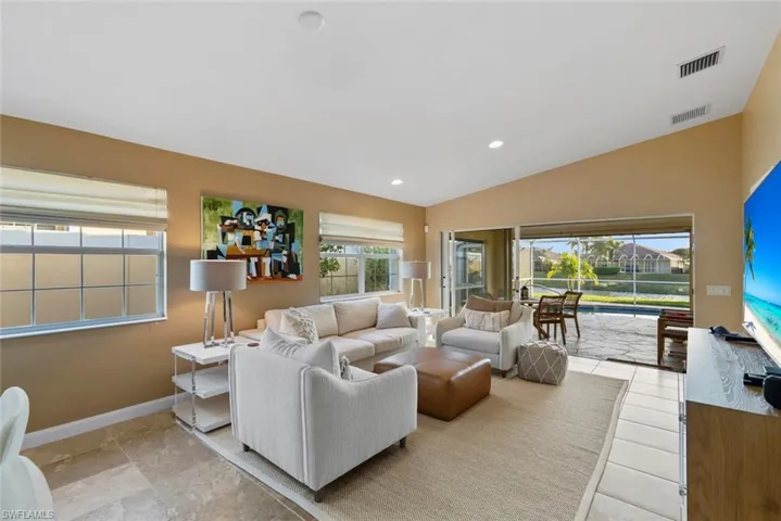 Living area with vaulted ceiling and recessed lighting