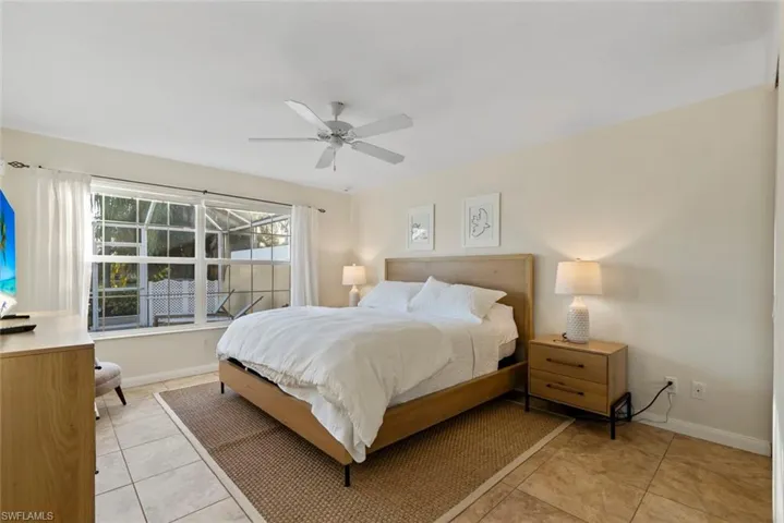 Bedroom with light tile patterned flooring and ceiling fan