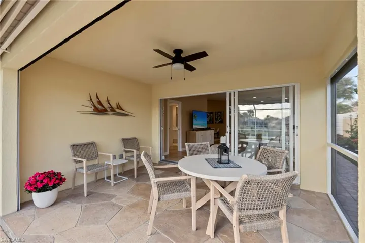 Patio with a ceiling fan and outdoor dining area