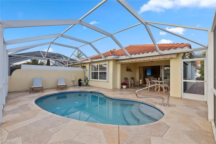 Swimming pool with screened in pool cage
