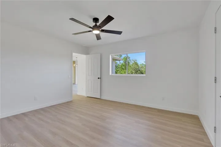 Unfurnished room with light wood-style flooring and ceiling fan