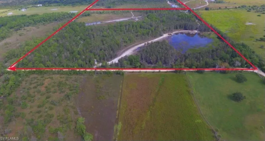 Birds eye view of property featuring a water view and a rural view
