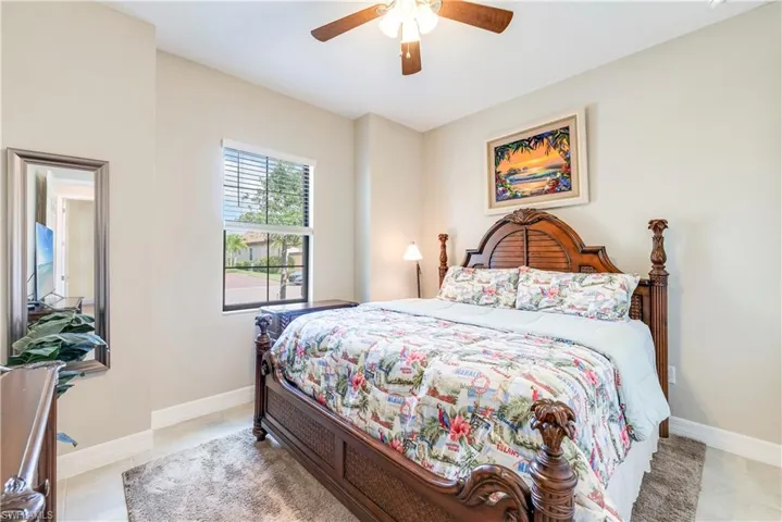 Bedroom featuring ceiling fan and baseboards