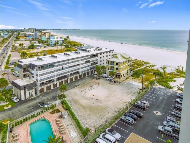 Drone / aerial view of expansive coastline and apartment complex / building