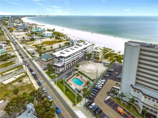 Drone / aerial view of extended coastline and a pool