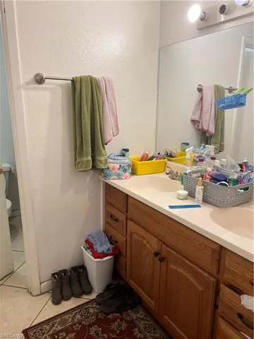 Bathroom with tile floors, vanity, and toilet