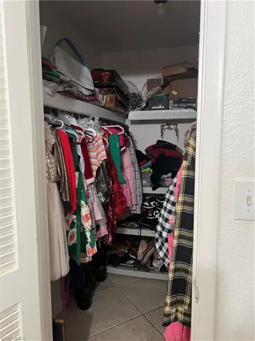 Walk in closet featuring tile floors