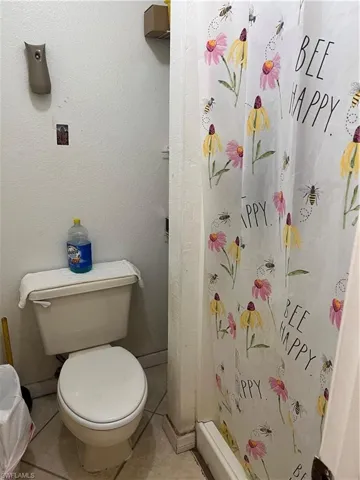 Bathroom with tile flooring and toilet