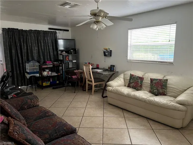 Tiled living room featuring ceiling fan